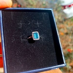 10k white gold ring with one 7.1x5.0mm emerald cut London blue topaz stone
